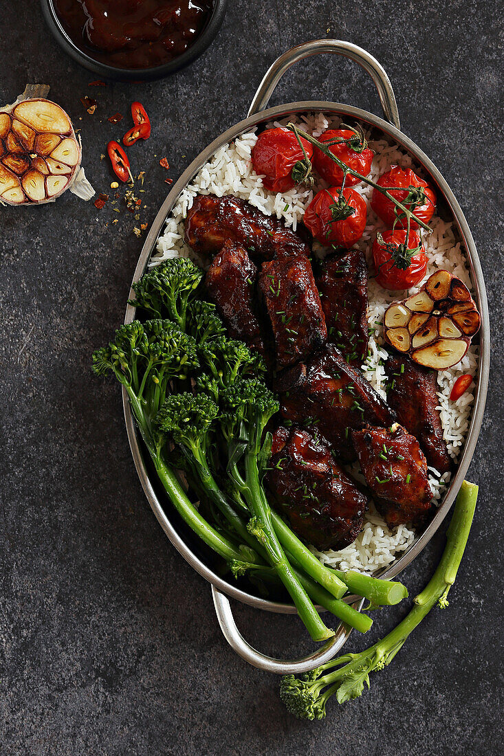 Asia style braised pork ribs with broccolini, roasted tomatoes and rice
