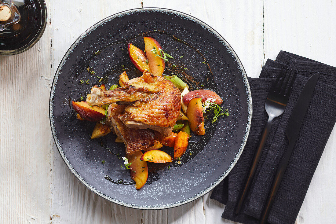 Roasted duck with vegetables and peach