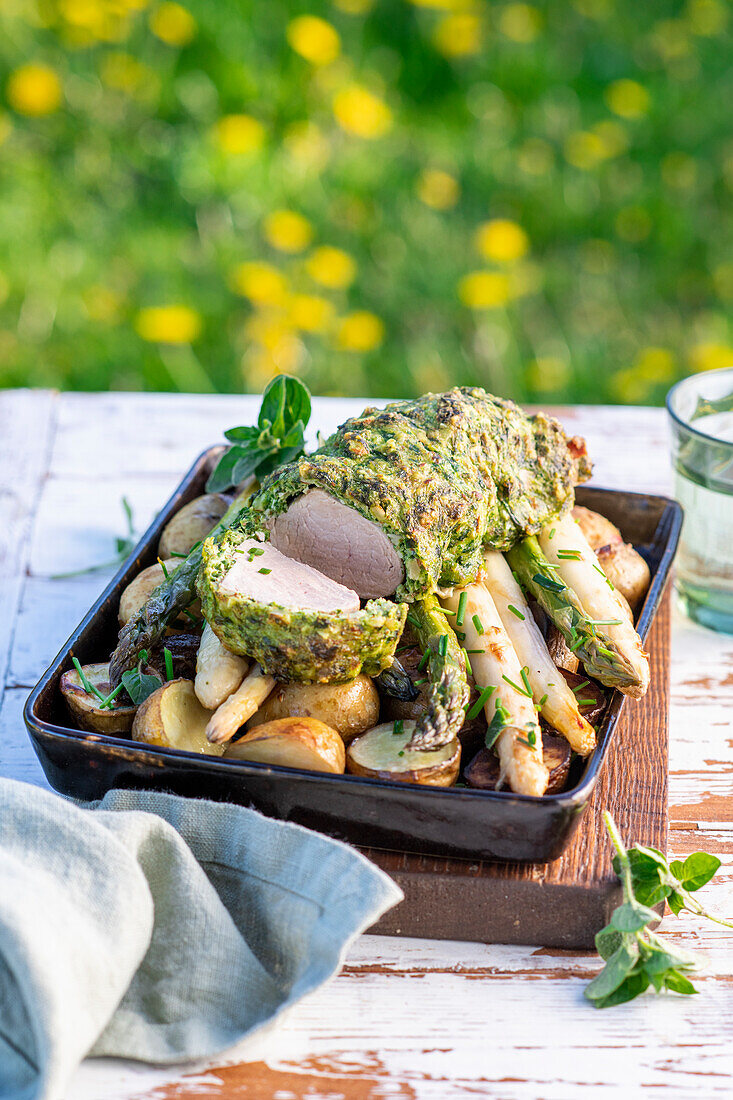 Pork fillet in herb crust with asparagus and potatoes