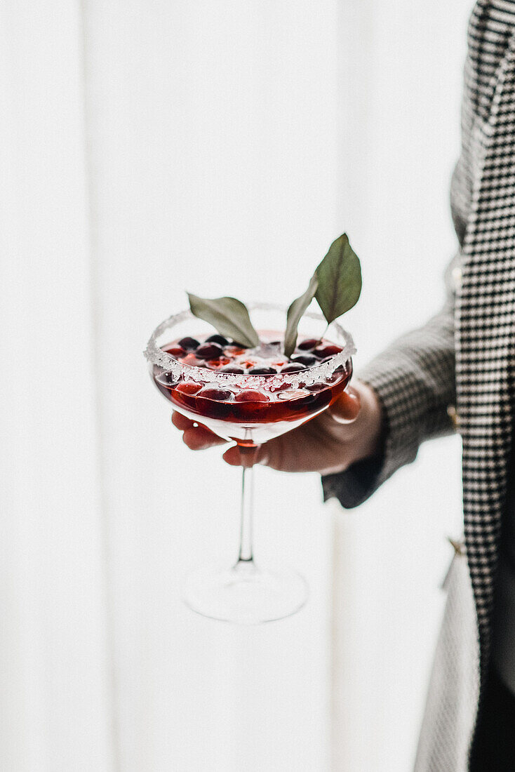 Hand Holding a Cranberry Drink