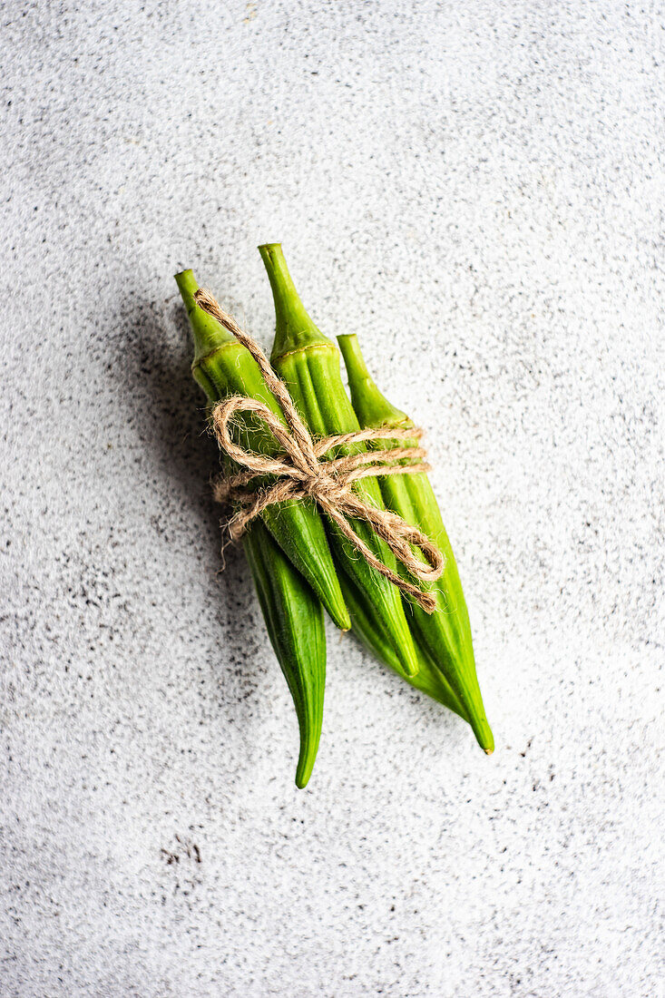 Bouquet of raw bamia vegetable on concrete background