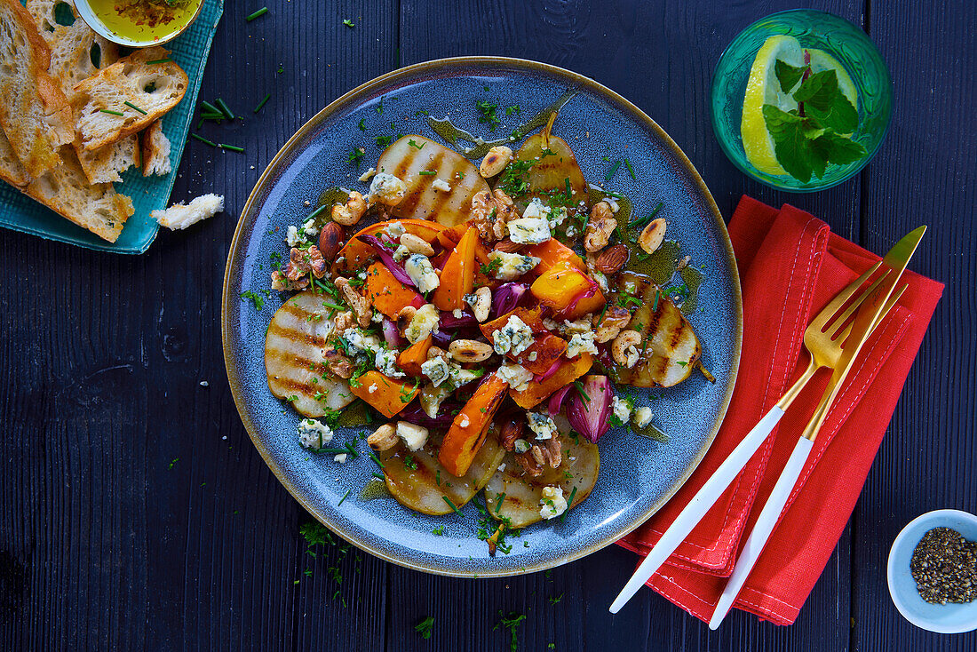 Grilled pear slices with pumpkin, red onions, and Stilton