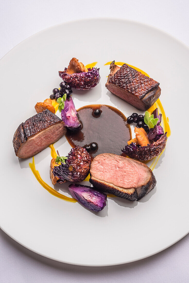 Roasted duck breast with roasted chanterelles, red cabbage, carrot puree and blueberry sauce