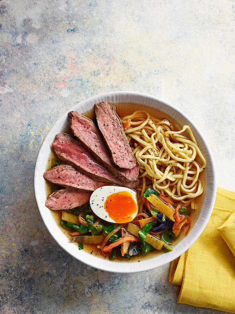 Asian beef ramen noodle bowl with egg