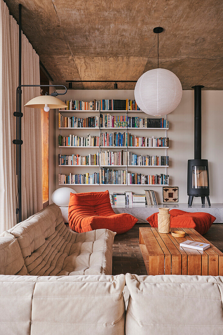 Cozy seating, wooden coffee table, wall of bookshelves and fireplace in a living room