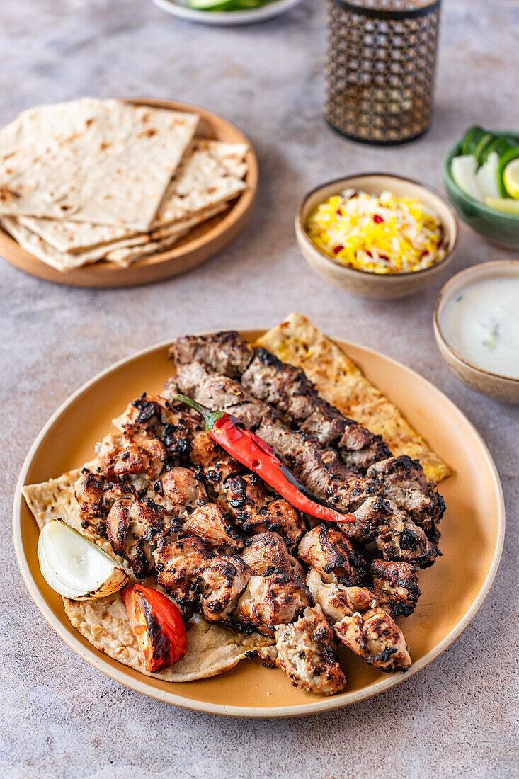 Chicken and beef skewers with tandoor bread, salad, rice and yogurt dip (Persia)