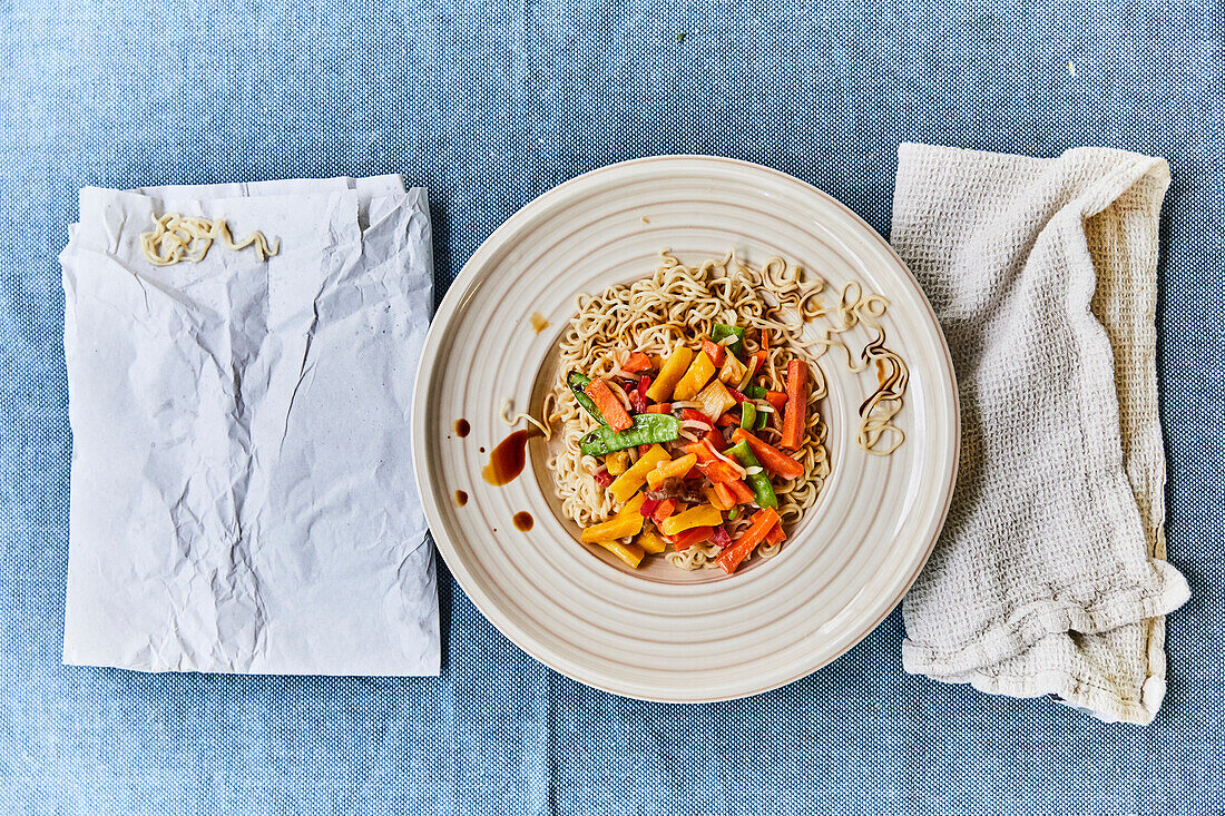 Stir fry vegetables over noodles