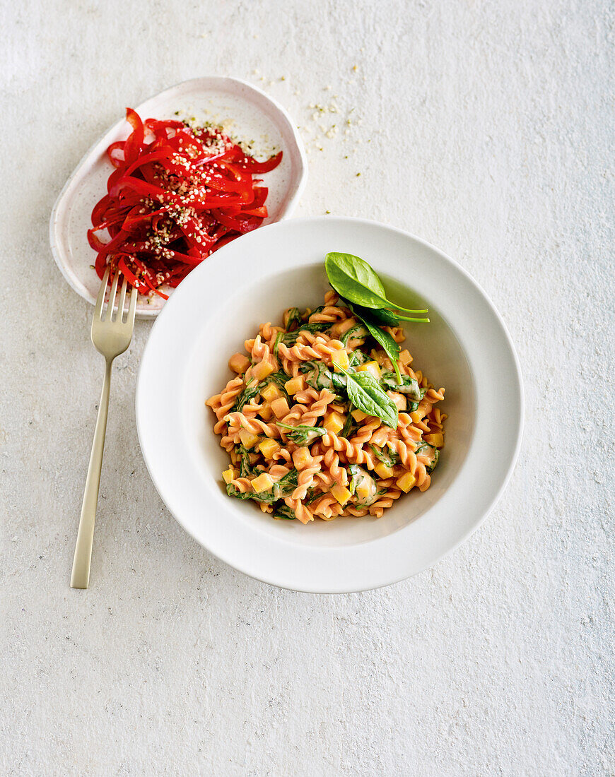 Vegan lentil pasta with almond sauce and raw vegetables