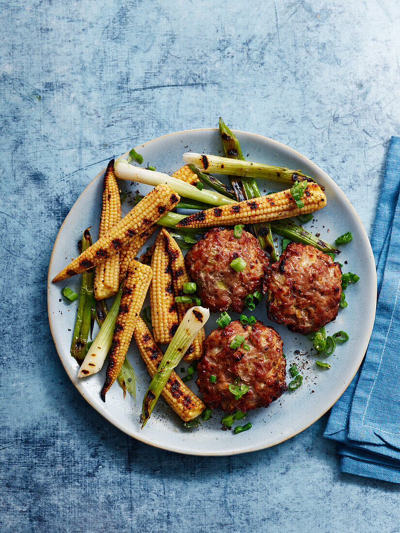 Pork and apple meatballs with baby corn and spring onions