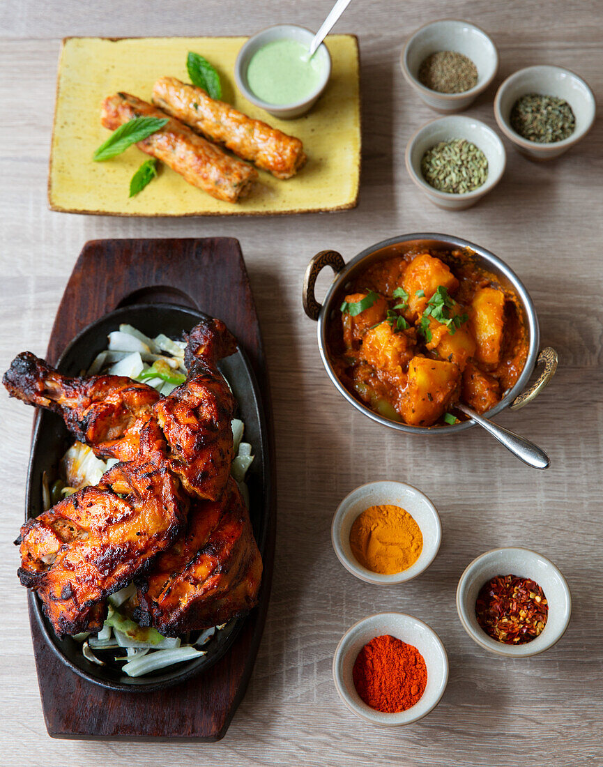 Tandoori chicken, kebab, and side dishes