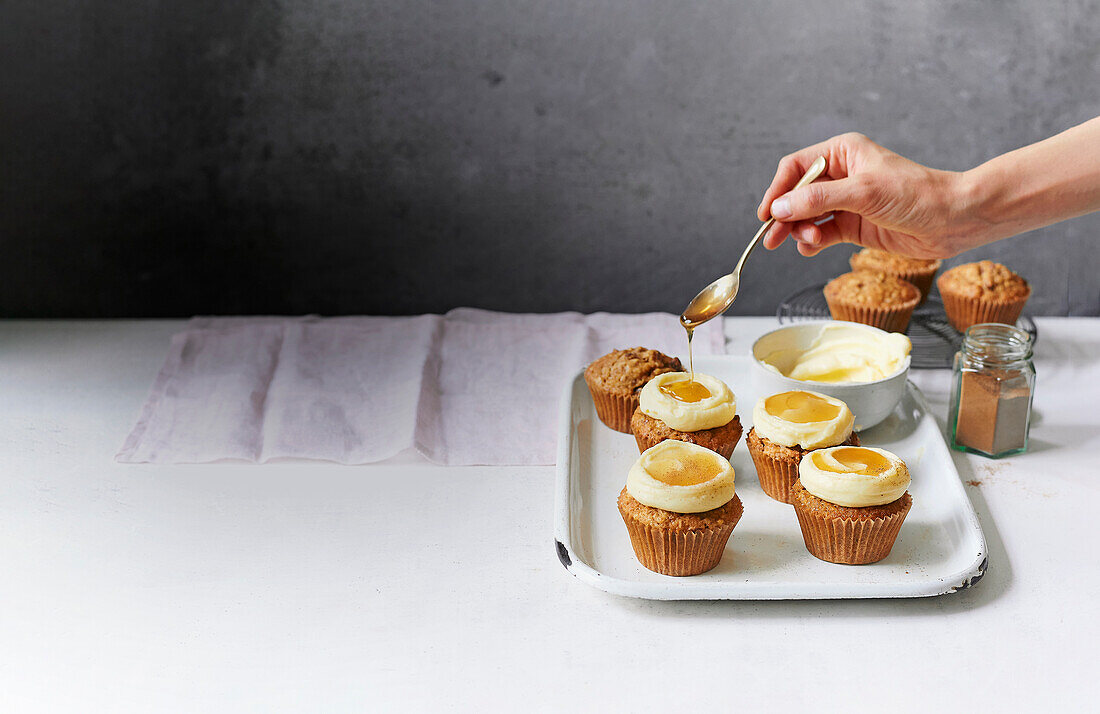 Sweet parsnip muffins with spices, cream cheese frosting, and maple syrup