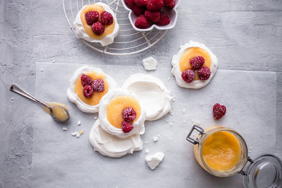 Mini pavlovas with lemon curd and raspberries