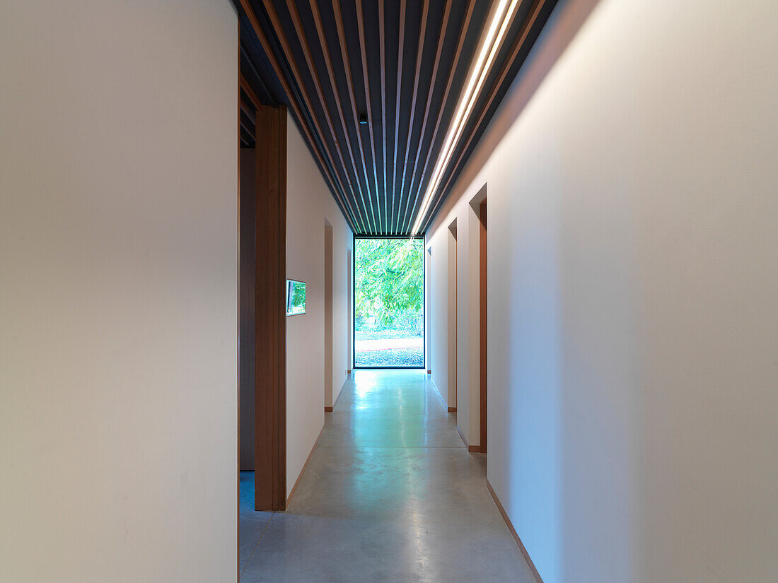 Narrow hallway with concrete floor