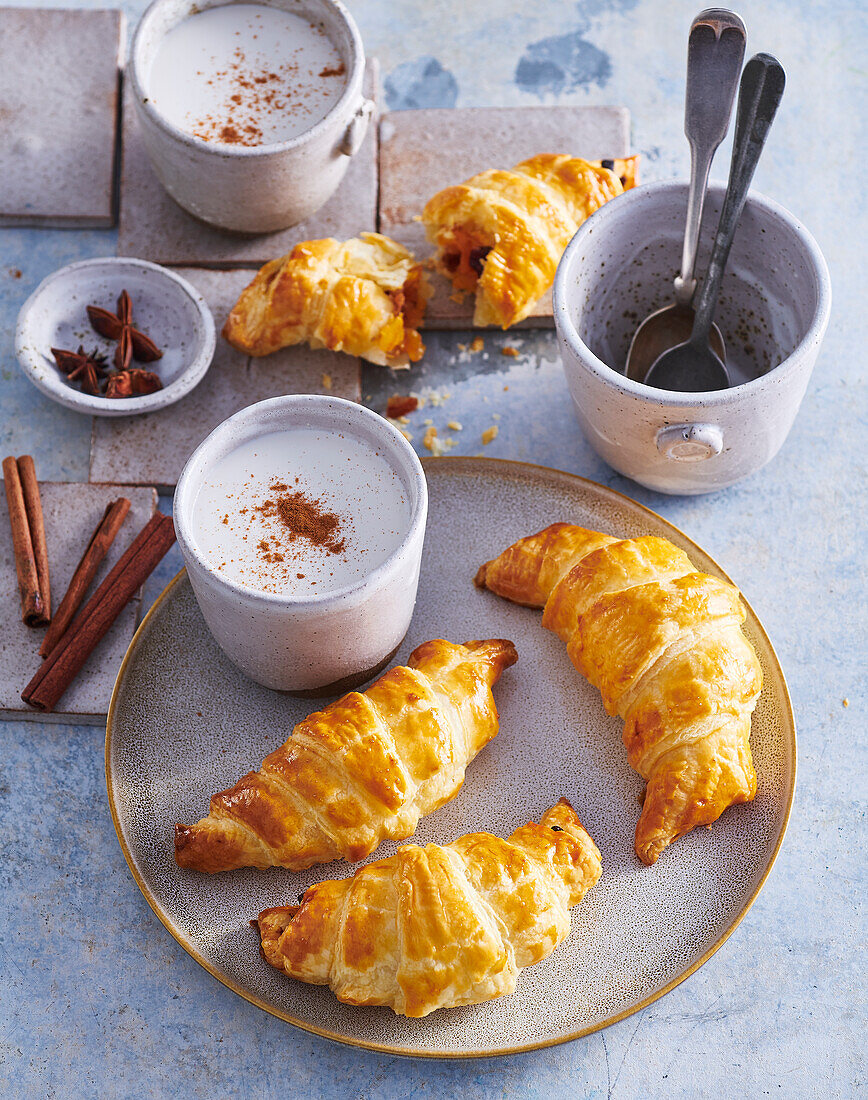 Croissants with dried fruit filling served with spiced coconut drink