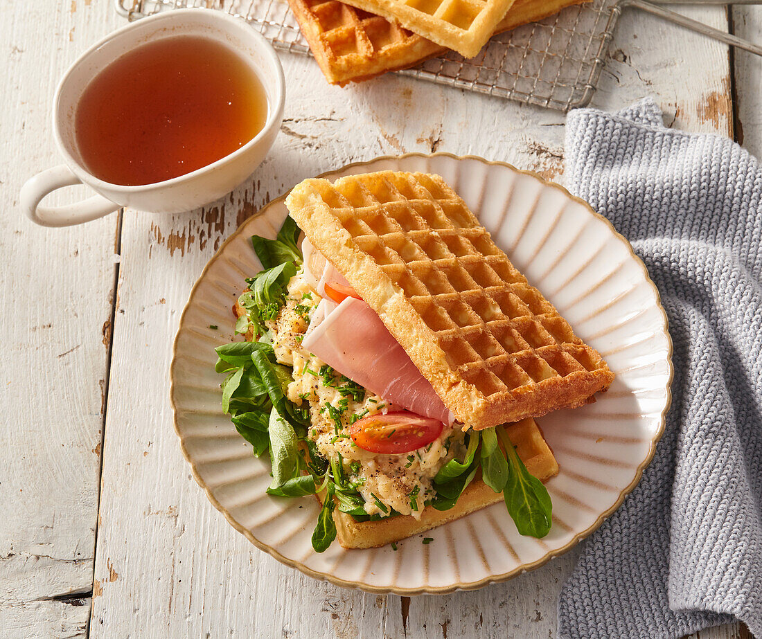 Waffle sandwich with scrambled eggs and ham