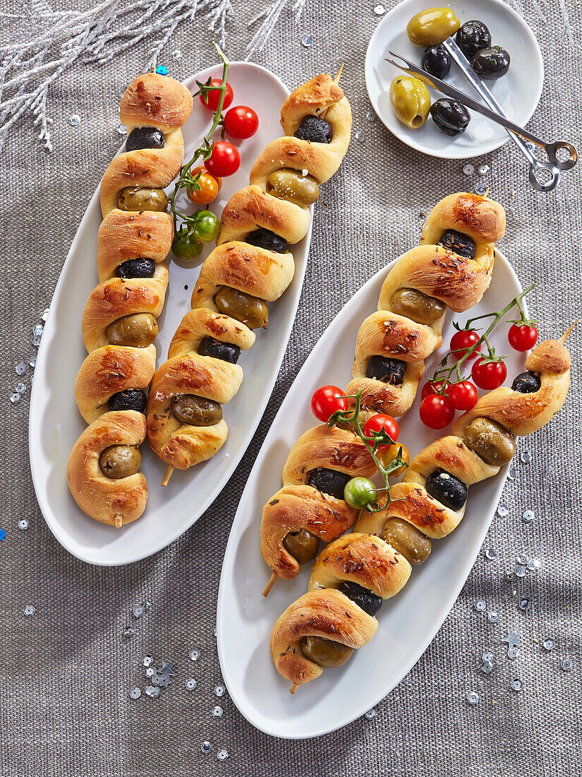 Skewered garlic bread sticks with olives