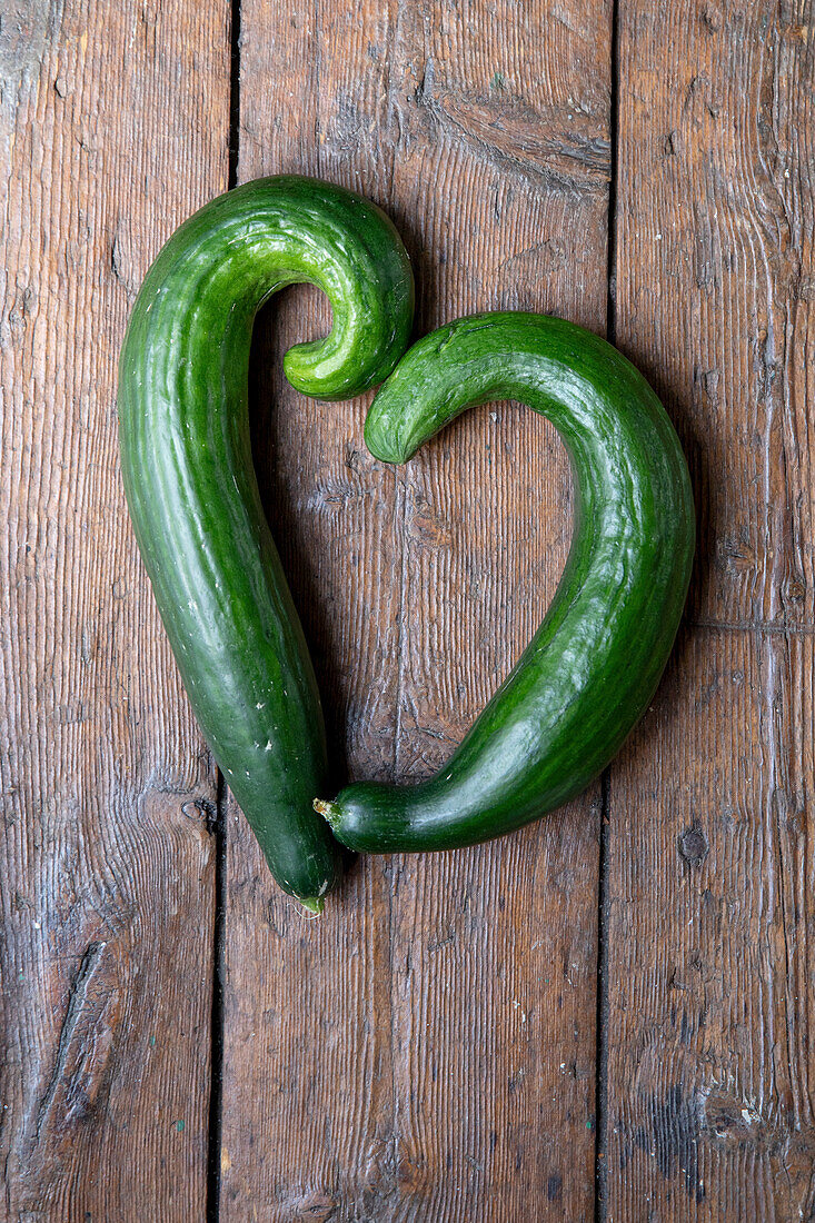 Two cucumbers on a wooden base