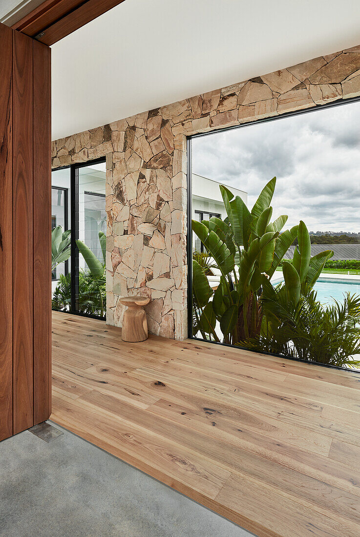 Palm Springs style front entrance with wooden entrance and stacked sandstones