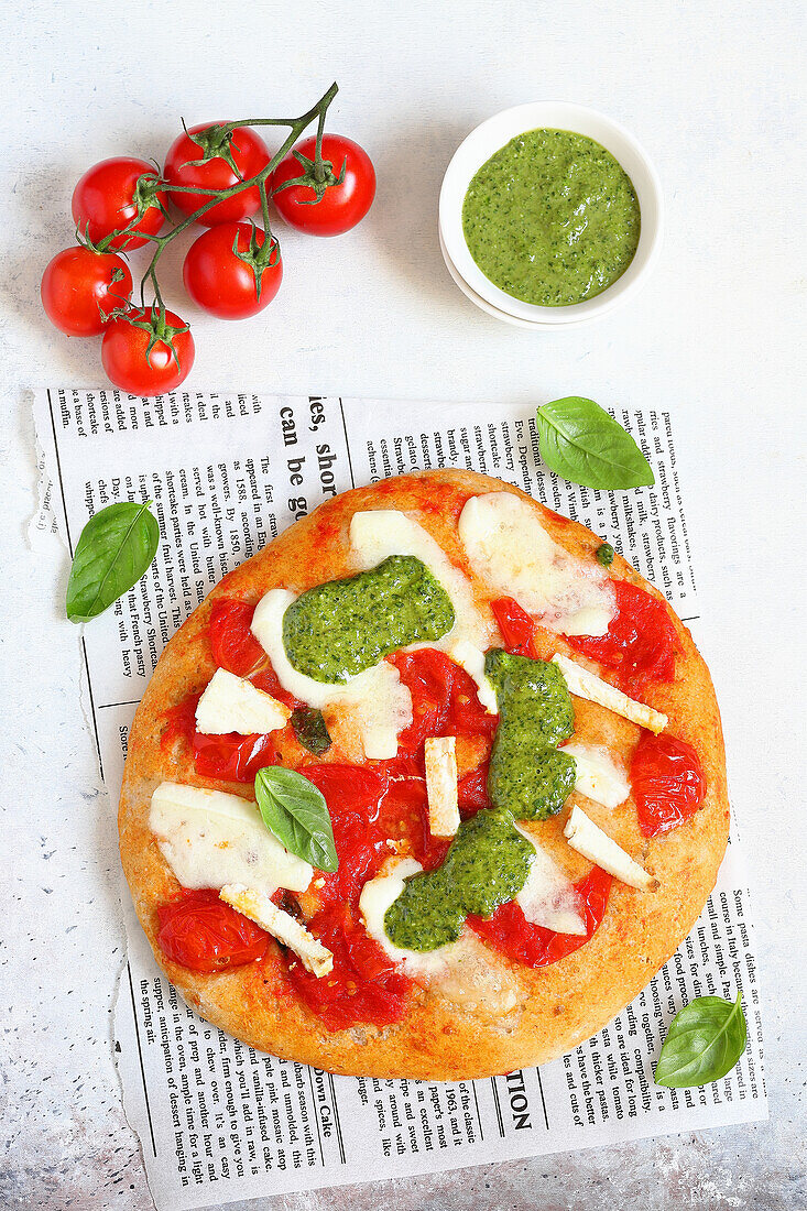 Tomato pizza with salted ricotta and pesto