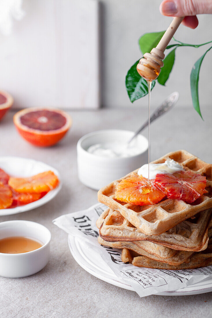 Breakfast waffles with blood oranges, yoghurt and honey