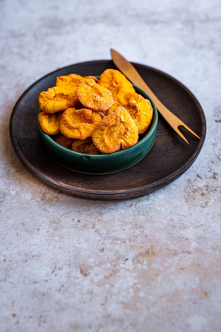 Dried peaches in a ceramic bowl