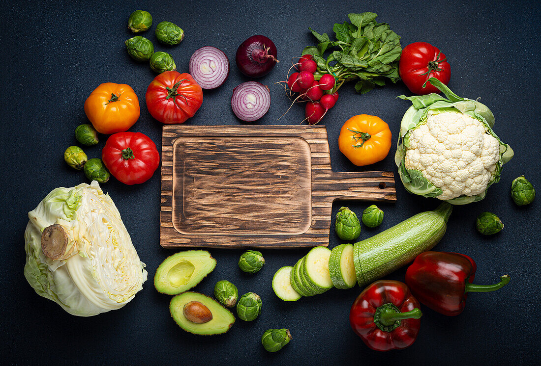 Fresh vegetables with a wooden chopping board