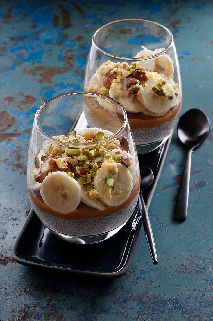 Layered caramel desserts with bananas, pistachios and chia
