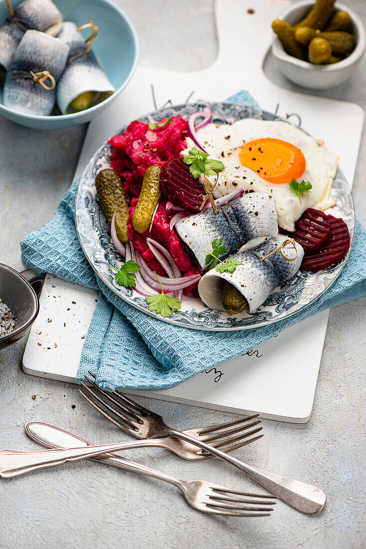 Labskaus with gherkins, rollmops and fried egg
