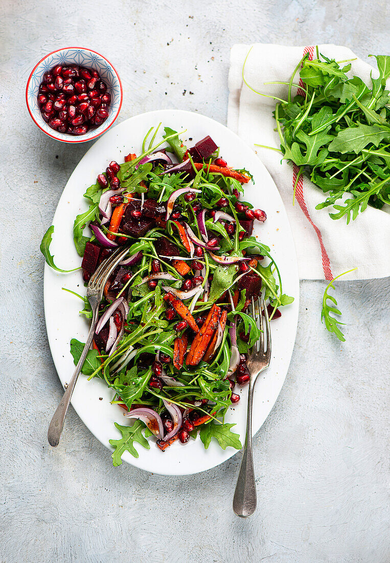 Beetroot salad with roasted carrots and pomegranate seeds