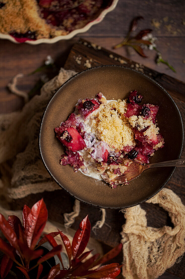 Apple and blackcurrant crumble with cream