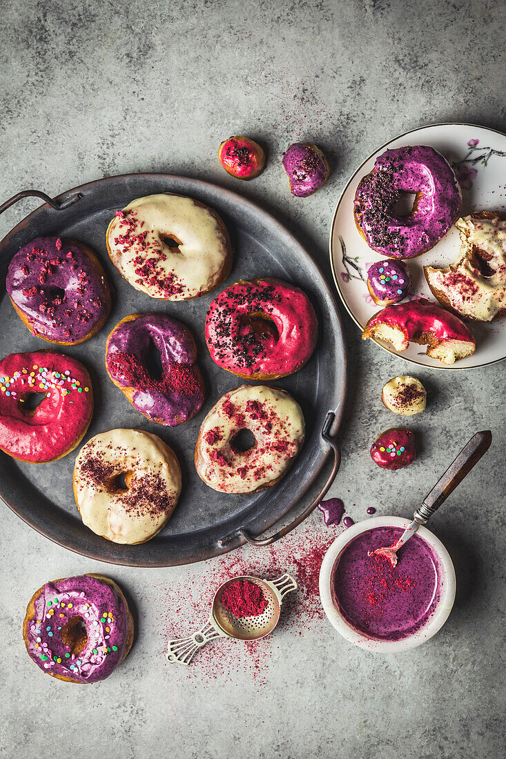 Donuts with berry-colored glaze and sprinkles
