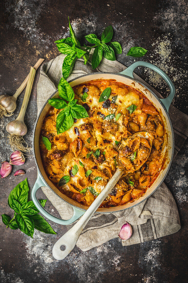 Baked pasta and cheese with sausages in a casserole dish