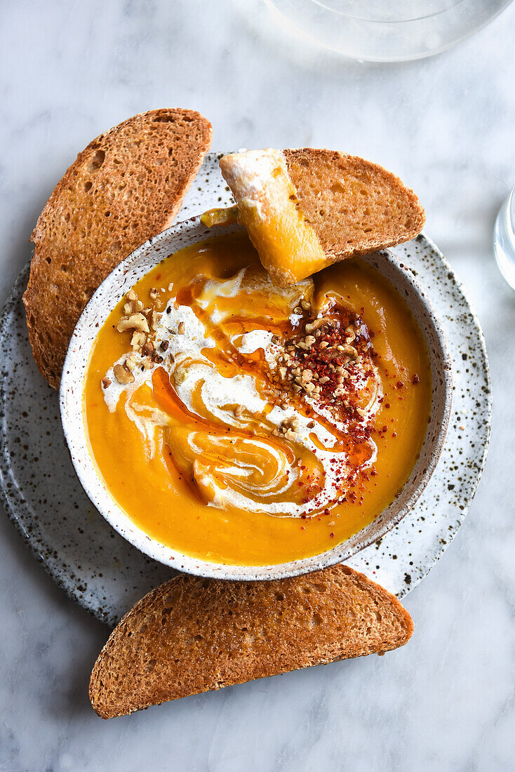 Pumpkin soup with yogurt, served with bread