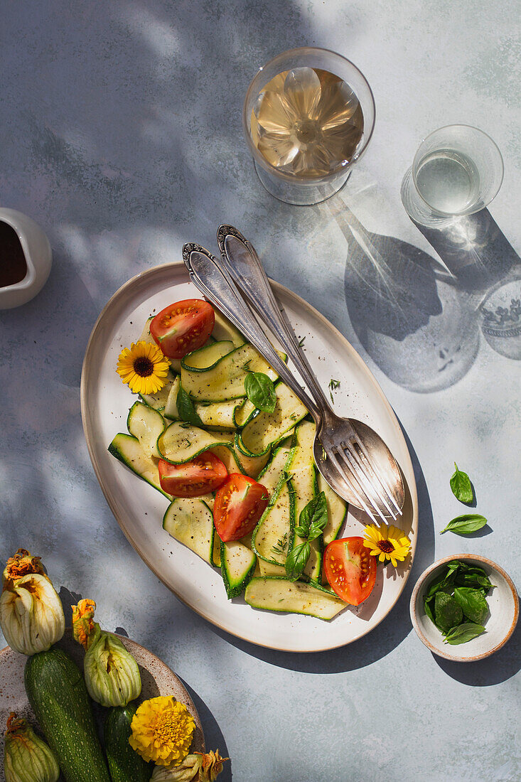 Thin sliced zucchini with tomatoes, basil and vinaigrette