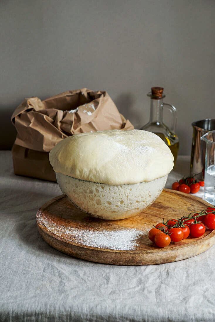 Rising yeast dough in a glass bowl, ready for kneading