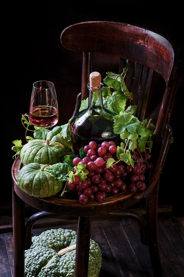 Autumn composition with wine and green pumpkins and grapes