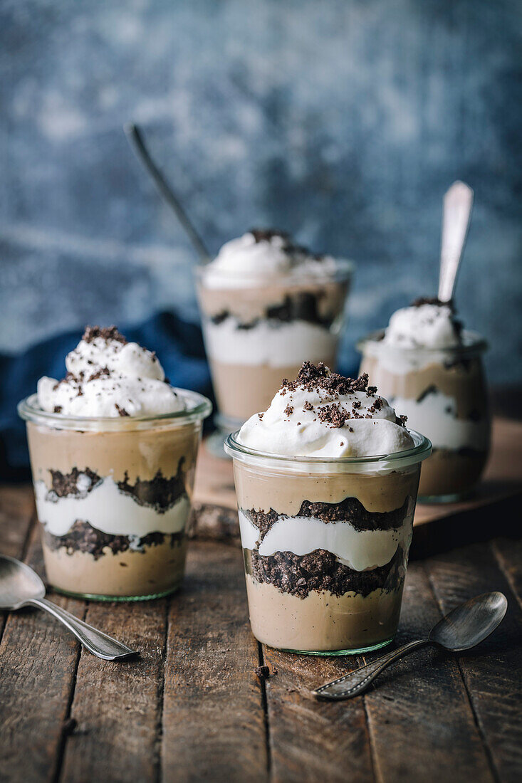Layered dessert with chocolate cream chocolate biscuits and whipped cream
