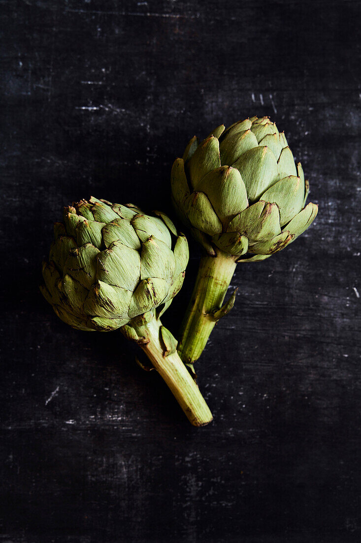 Fresh artichokes on a black background