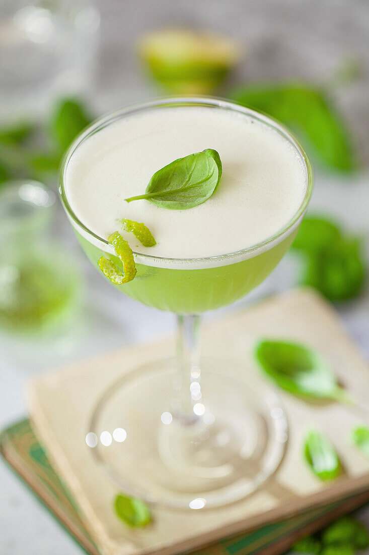 Gin cocktail with basil, lime, and egg white foam