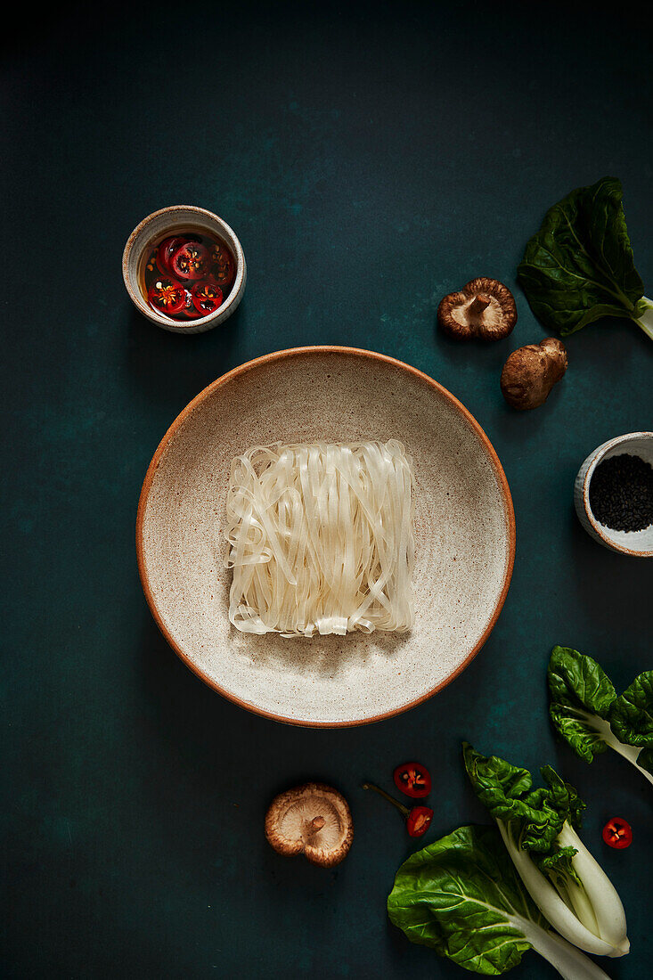 Mushrooms, bok choy, chili peppers and rice noodles