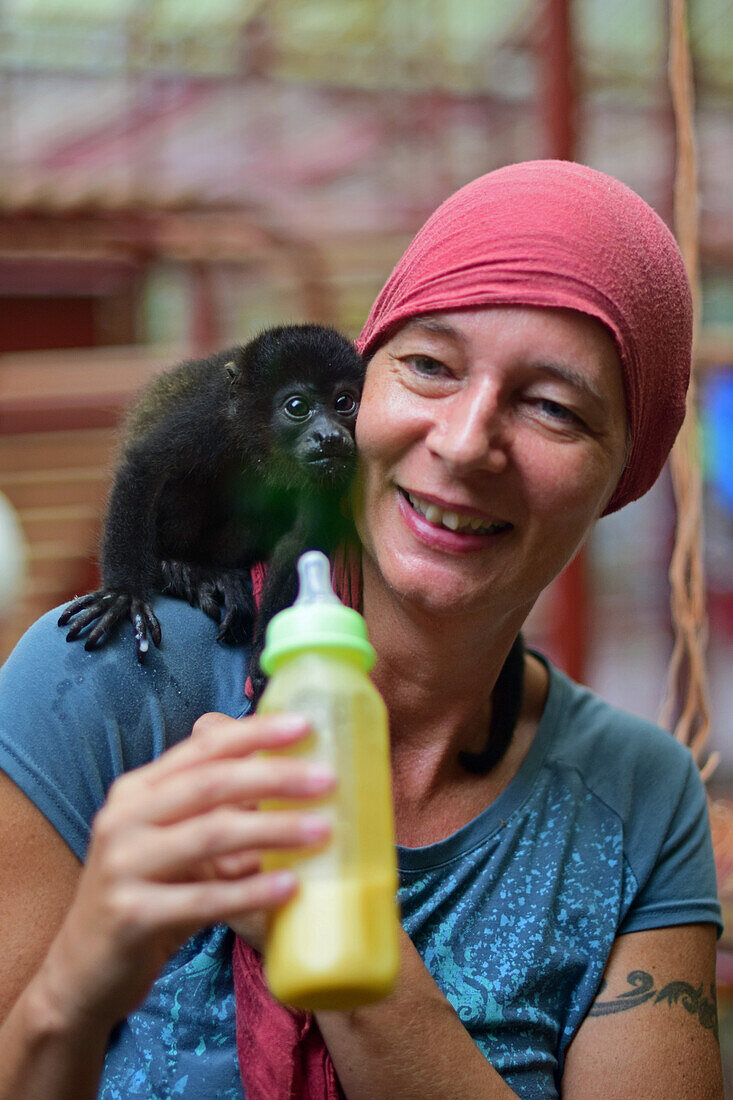 Woman feeding howler monkey