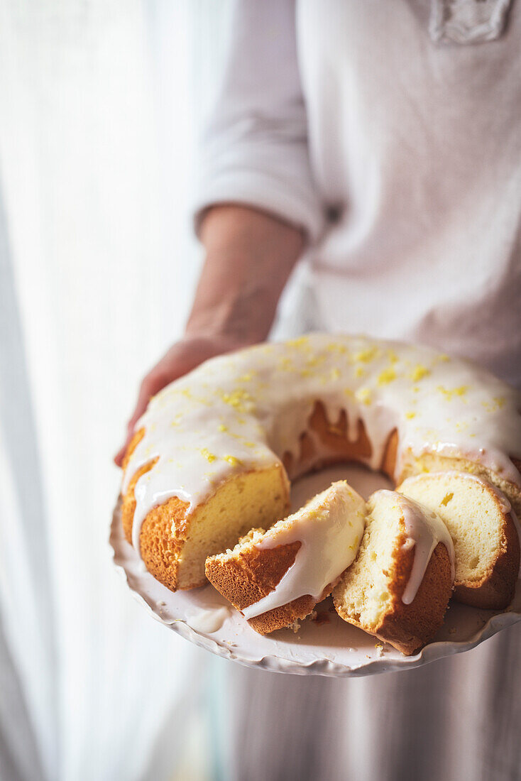 Bundt cake made of sponge cake batter with lemon icing