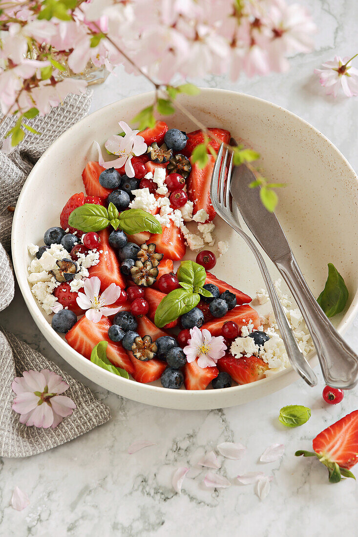 Light spring salad with berries and goat cheese