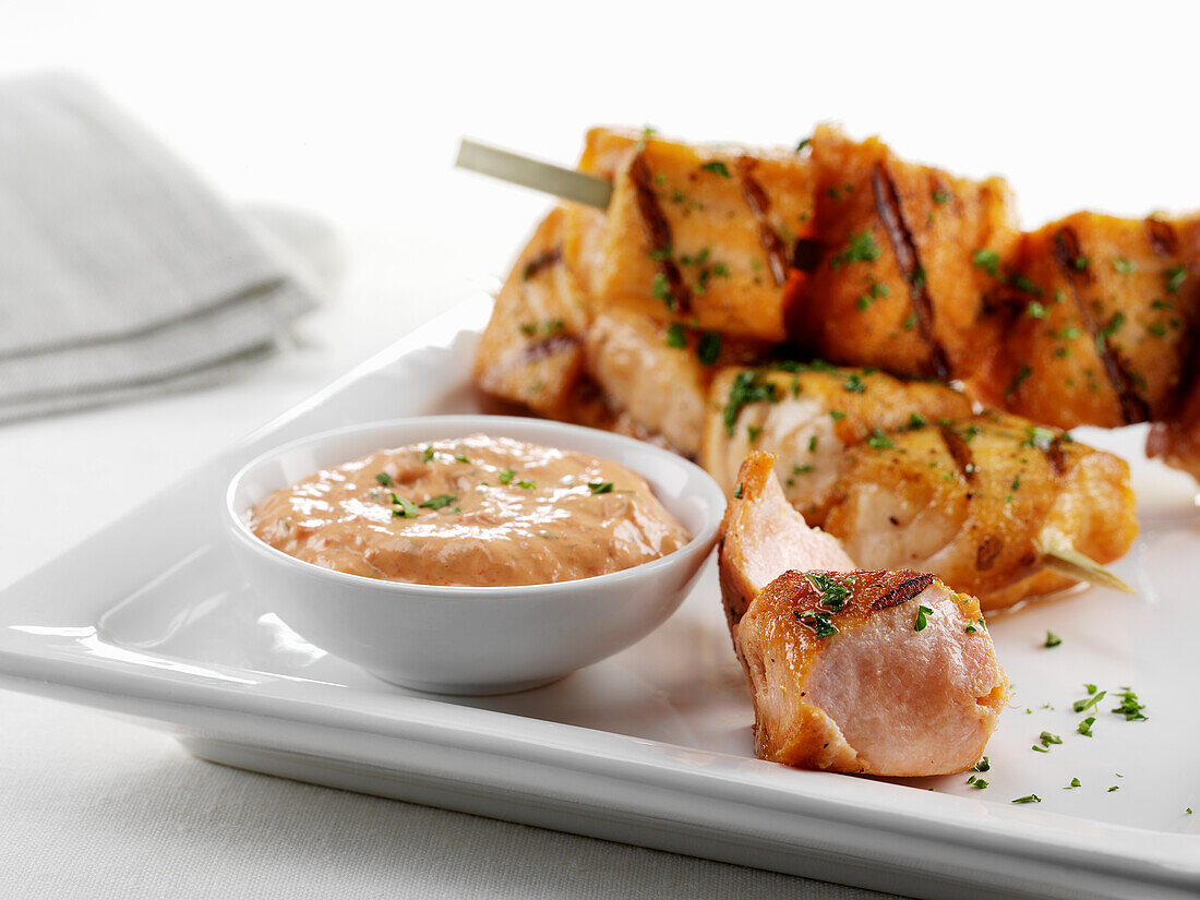 Salmon skewers with herbs and dip