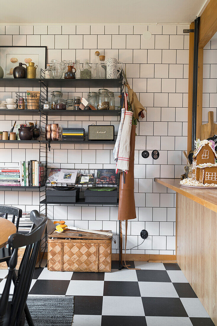 Kitchen with black and white checkered floor, wall tiles and shelving system