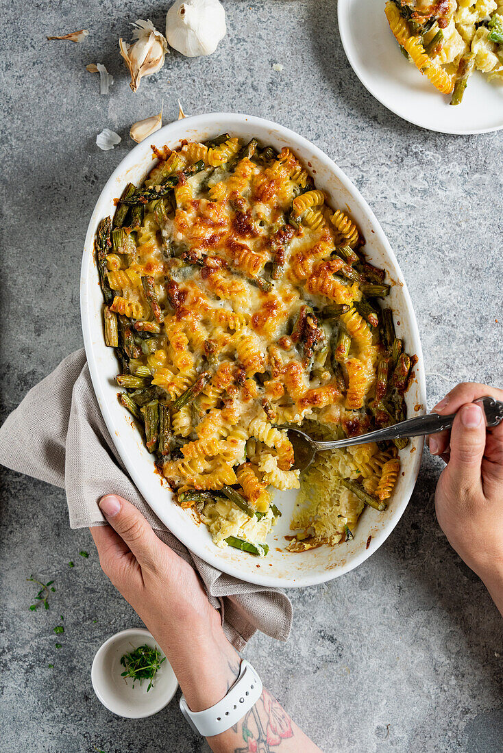 Pasta casserole with asparagus, cream, sour cream, parmesan and mozzarella cheese