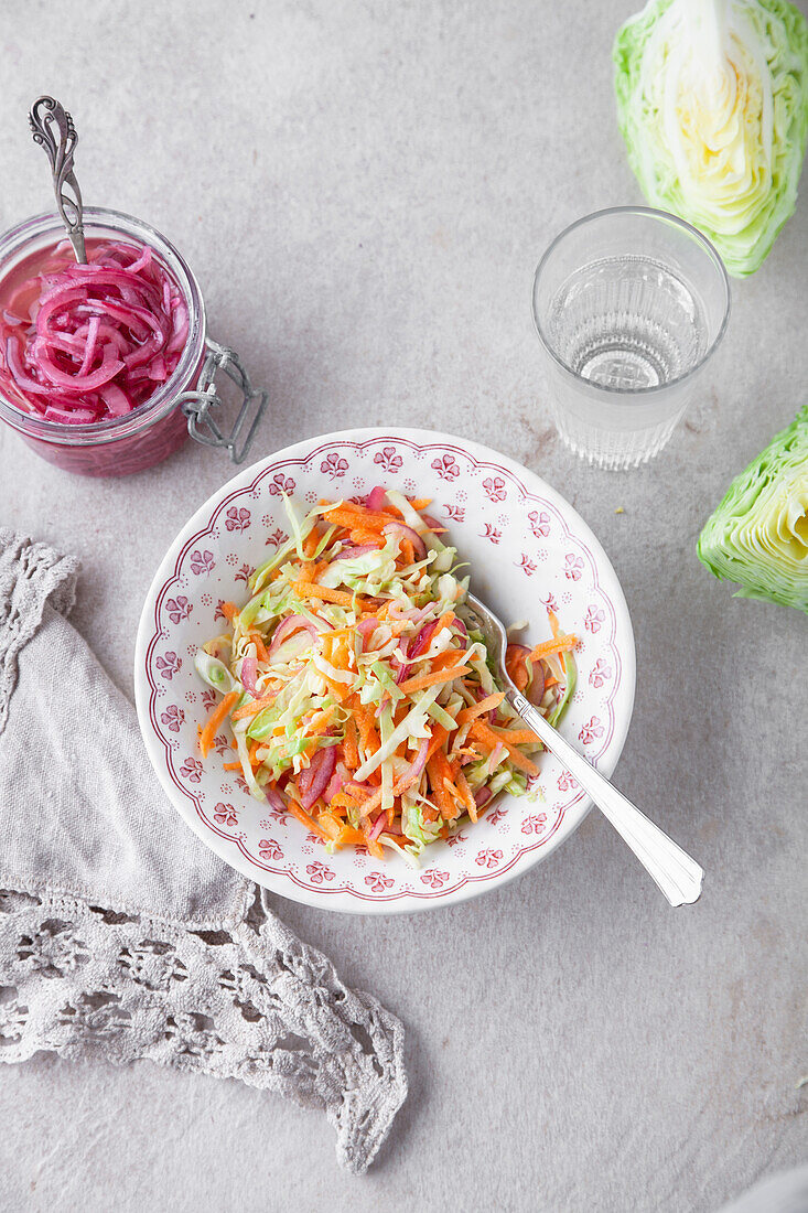 Cabbage salad with spring cabbage, carrots, and pickled red onions