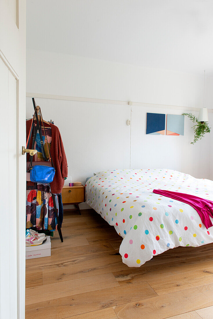 Bedroom with polka dot bed linen and wall decoration