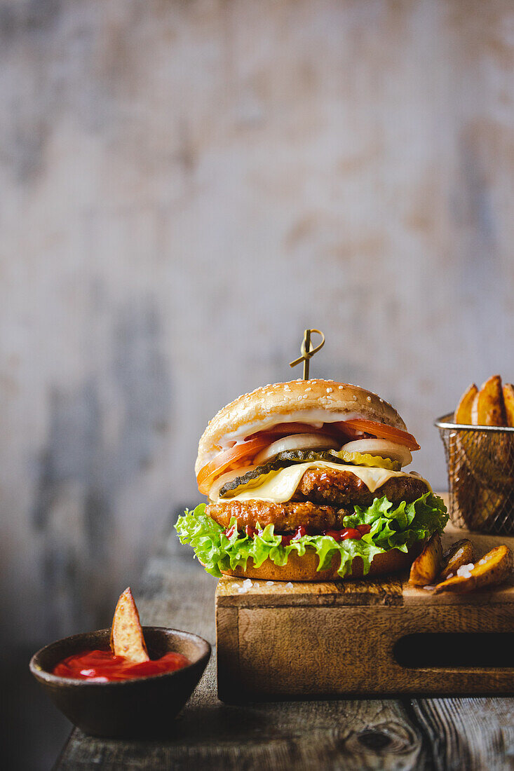 Hamburger with tomatoes, gherkins, onions