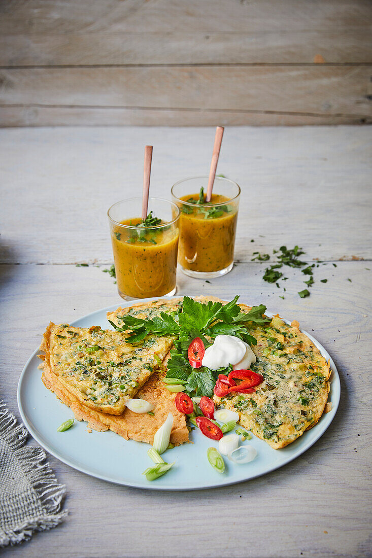 Omelette with herbs and spring onions served with vegetable smoothies
